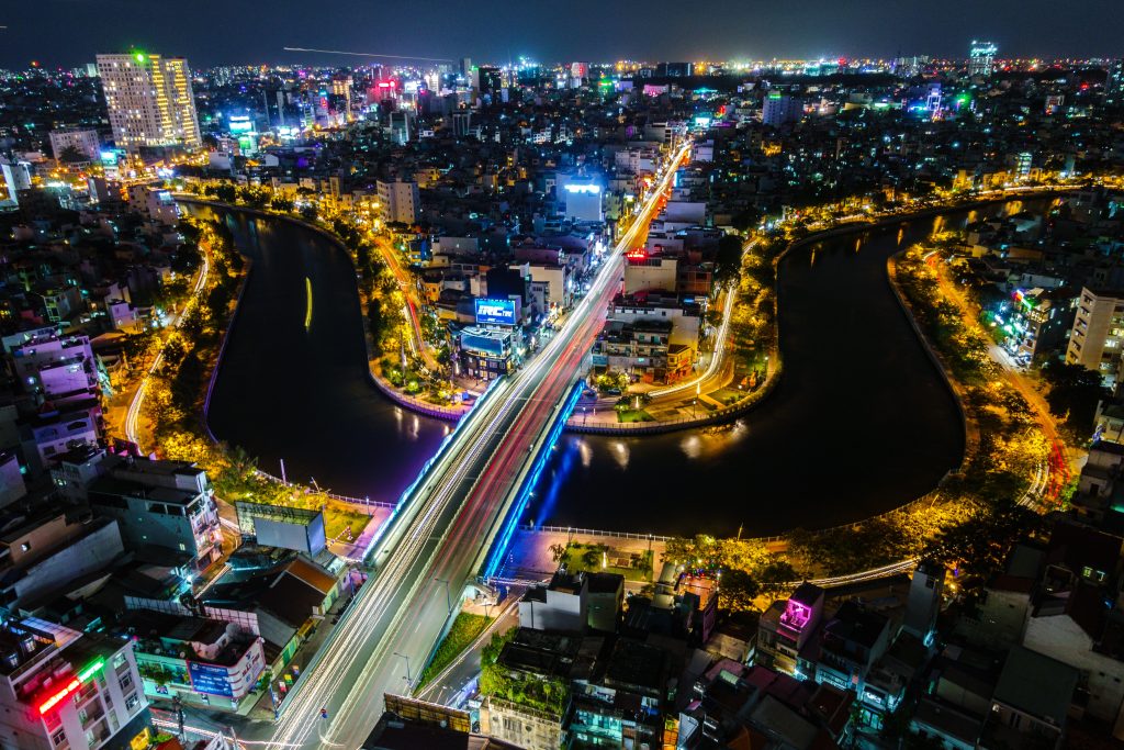 city seen from above at night, buzzing with light