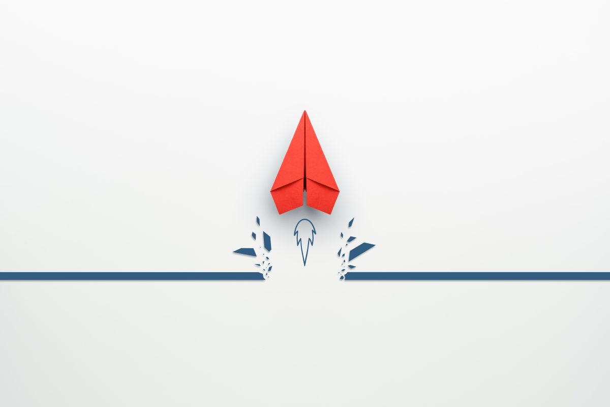 simple design of red paper plane breaking through a line to portray the concept of overcoming barriers
