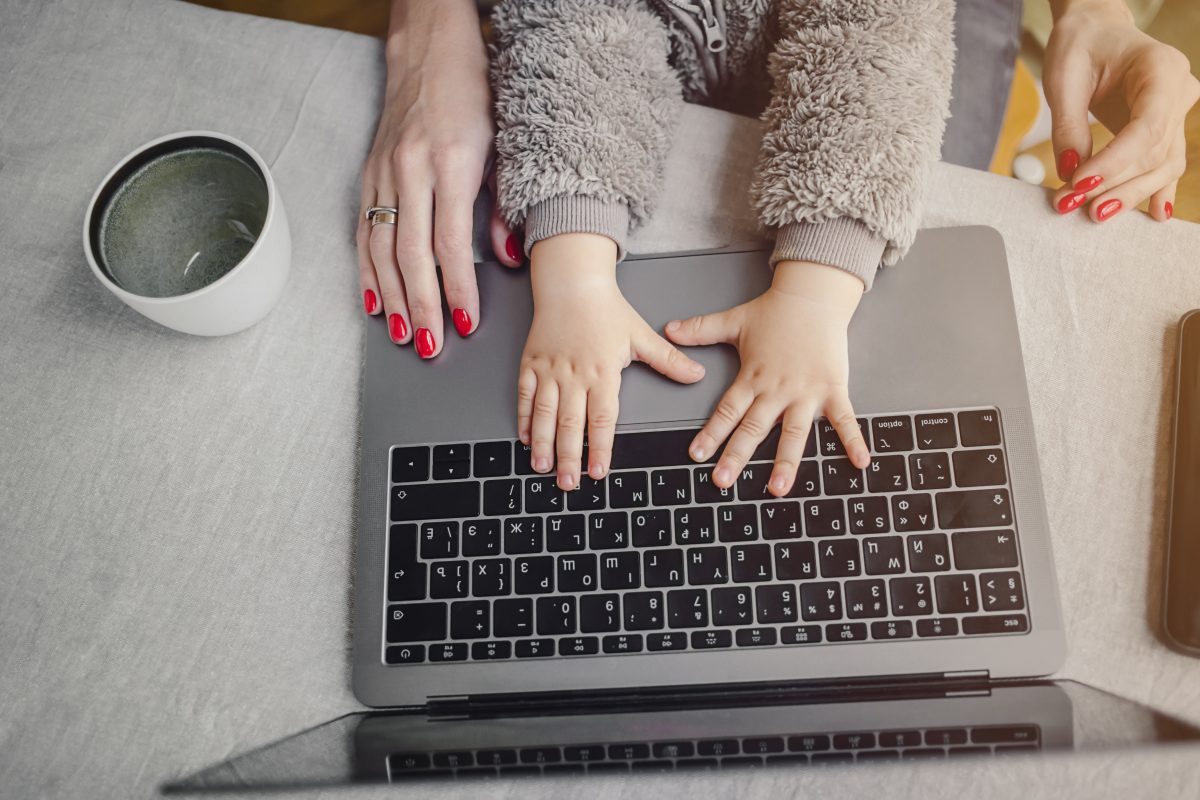 a mother and a child using a laptop