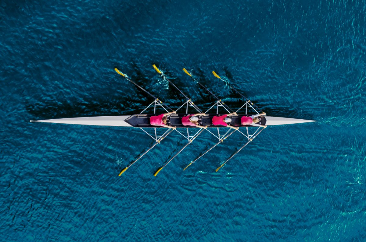 rowing boat seen from above on blue waters