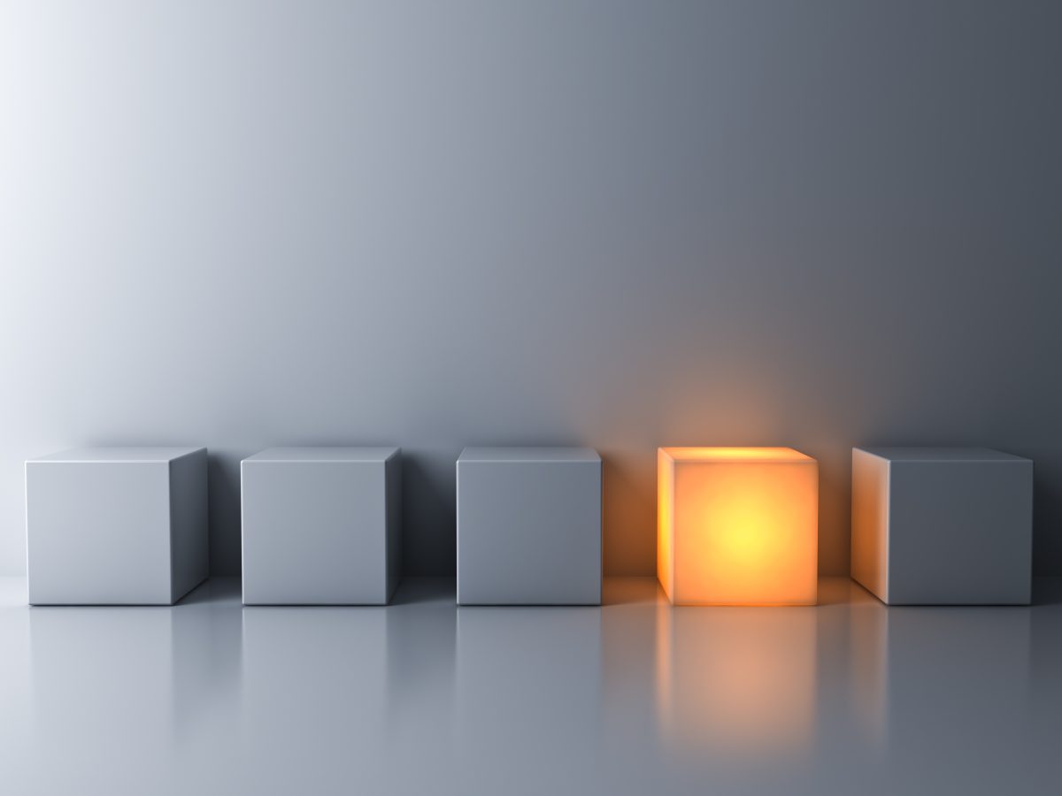 Abstract 3d image of 4 white boxes and 1 glowing box