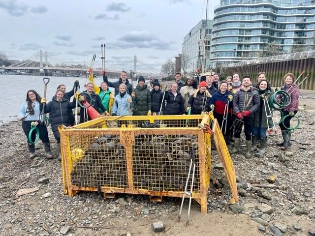 Photo of a group of Leathwaite employees picking rubbish from a beach for Thames 21.