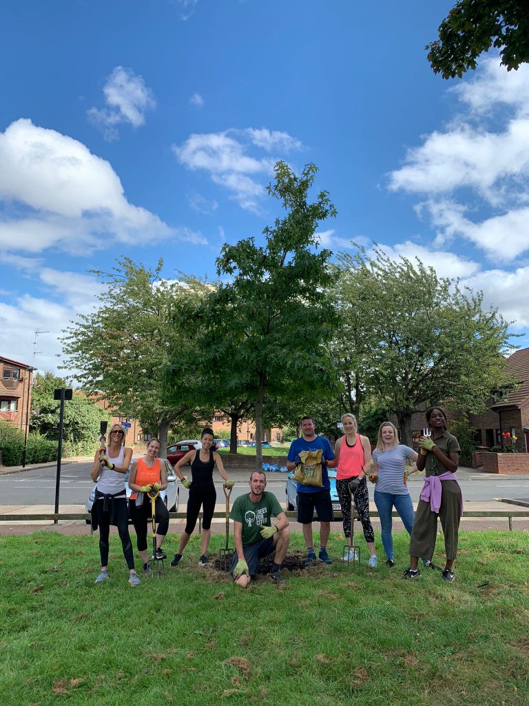 Image of eight Leathwaite employees in front of three trees