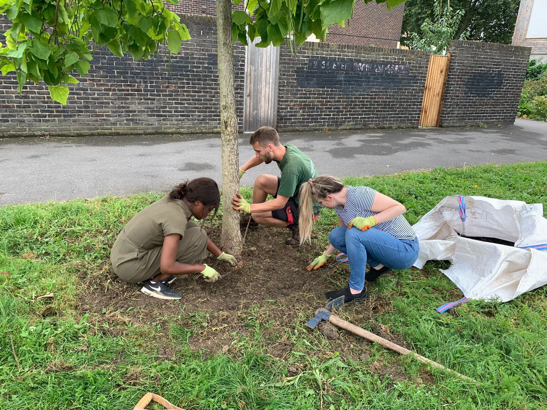 Image of three Leathwaite employees planting a tree