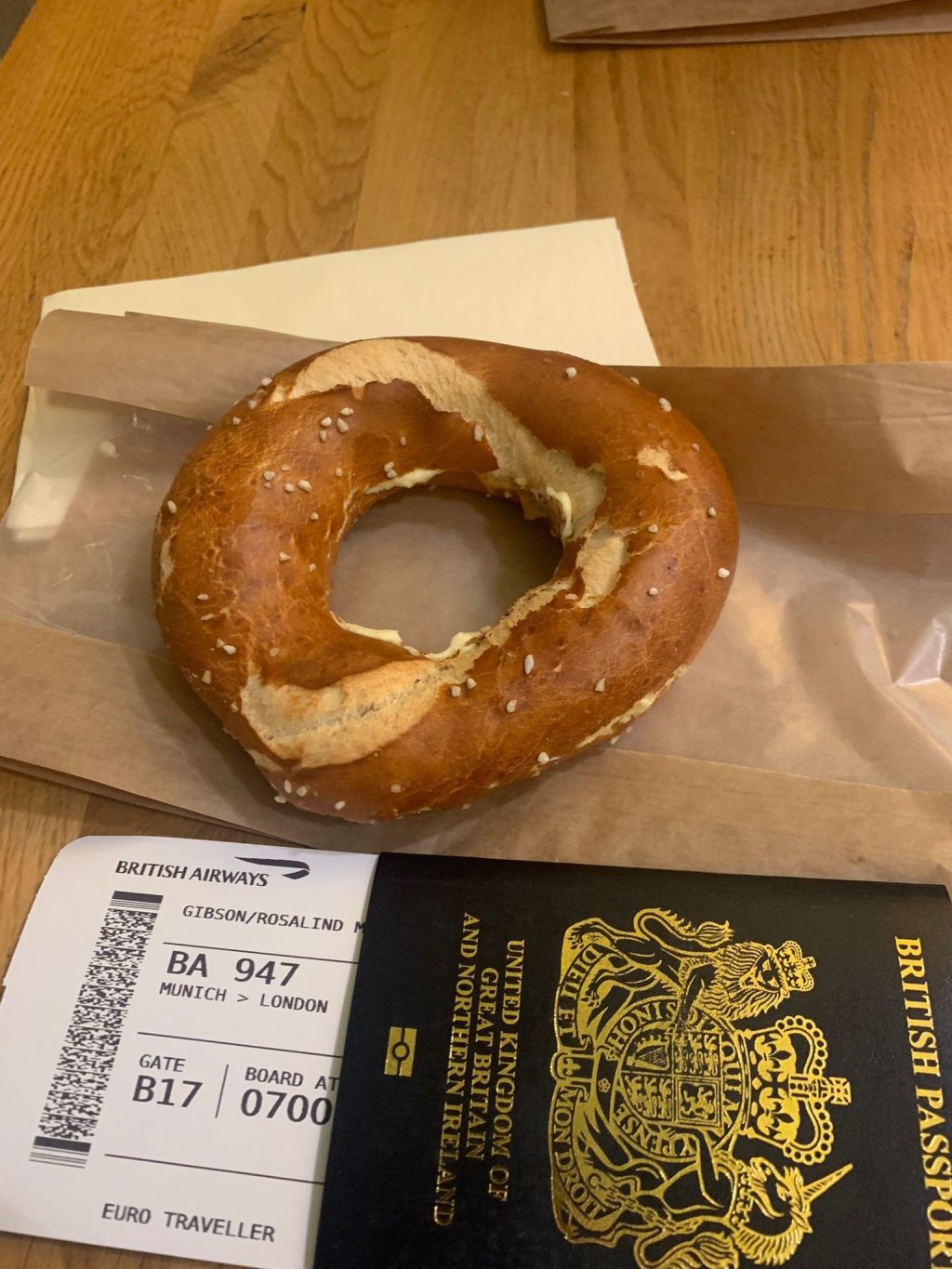Photo of Rosie Gibson's passport, plane ticket and a bagel.