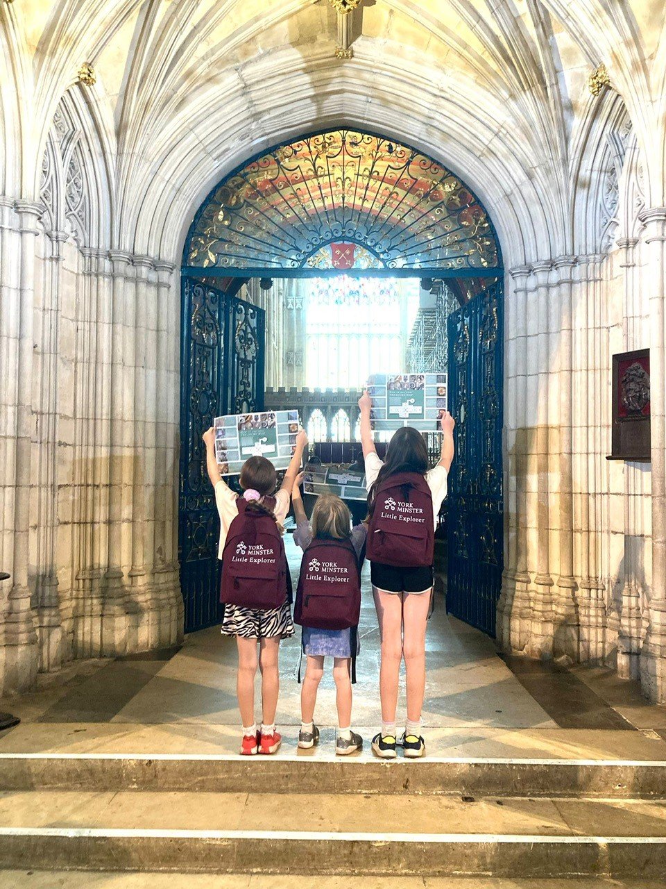 Photo of 3 kids in front of a cathedral in the North of England.