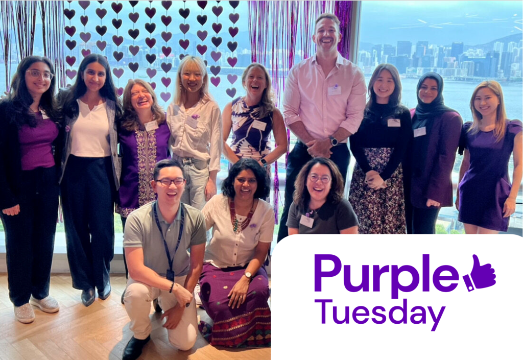Photo of Leathwaite Hong team standing in front of a window for Purple Tuesday