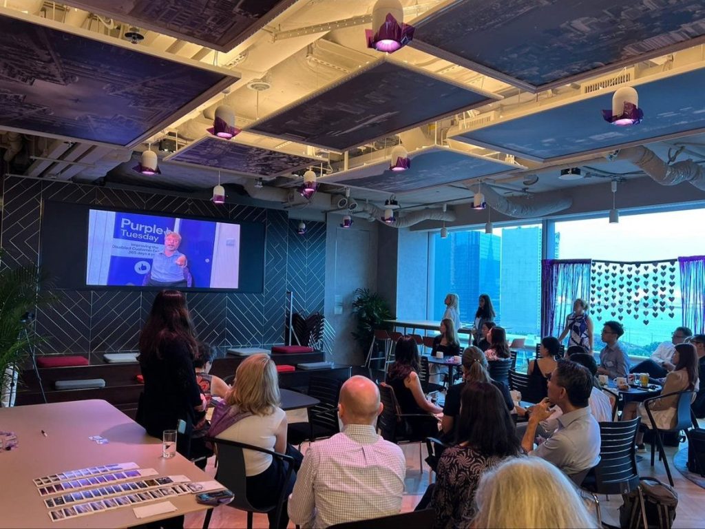 People sat watching a Purple Tuesday presentation
