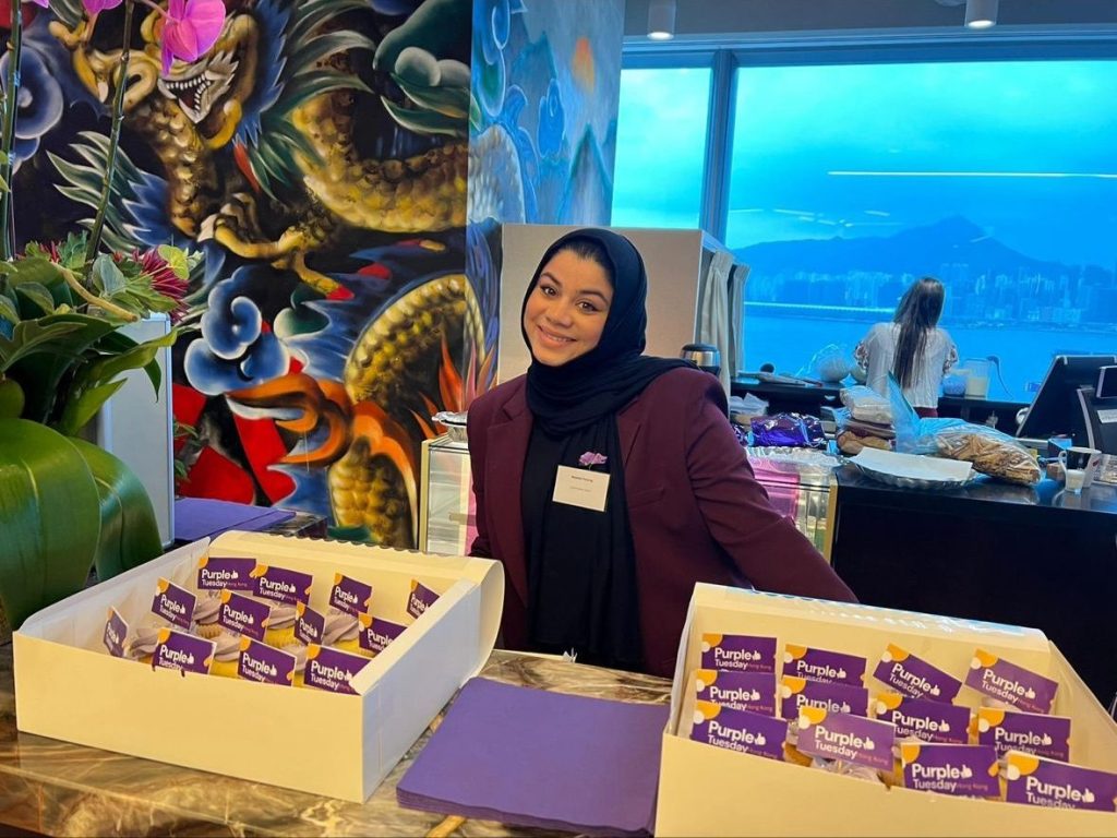 Leathwaite staff member with boxes of Purple Tuesday branded cupcakes