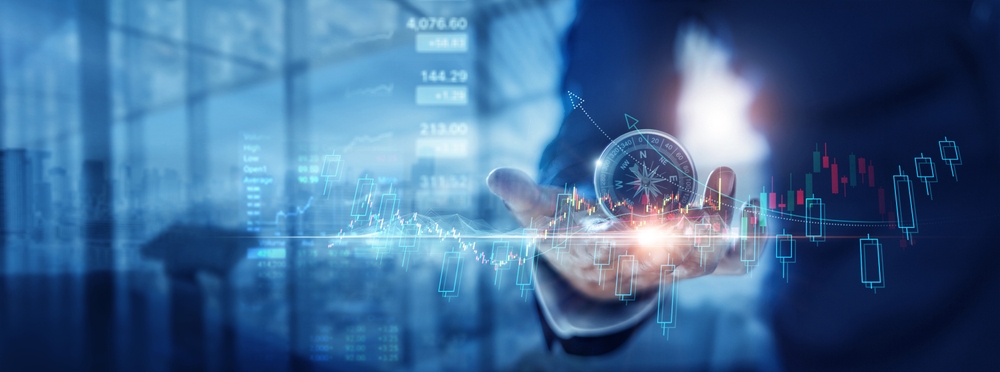 Businessman holding compass to navigate business growth and vision