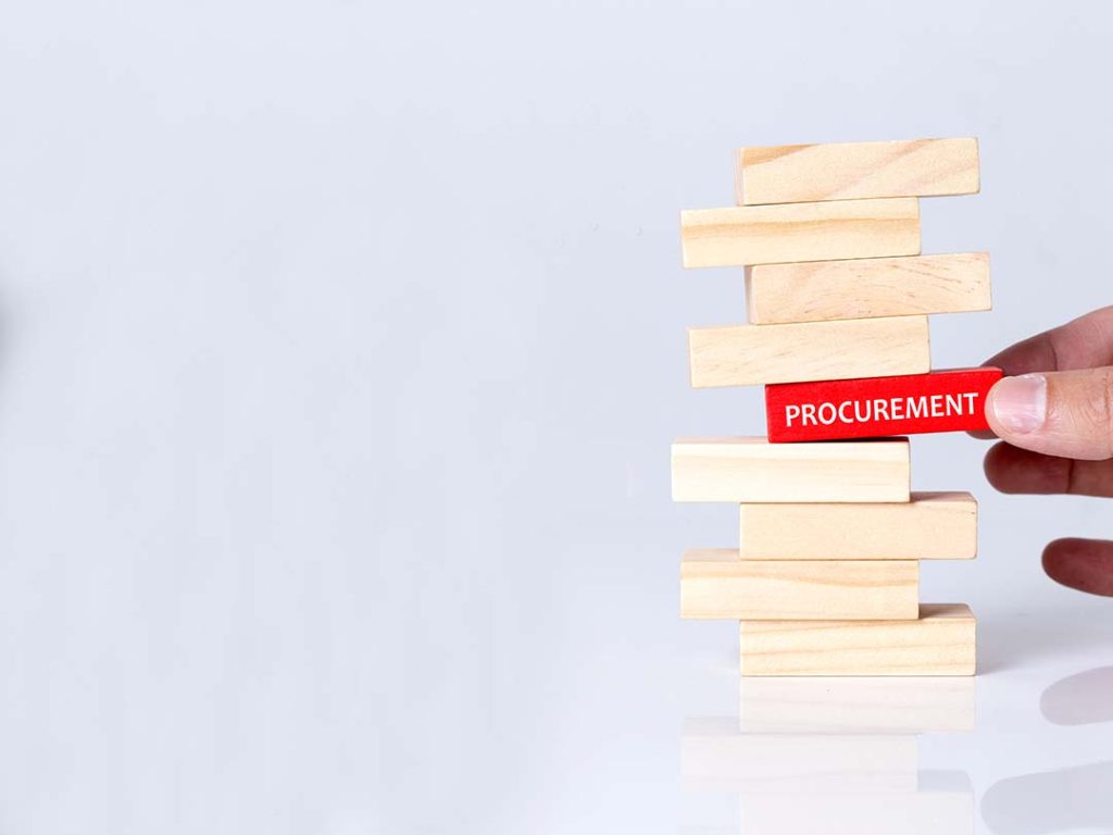 red jenga piece with the word procurement on