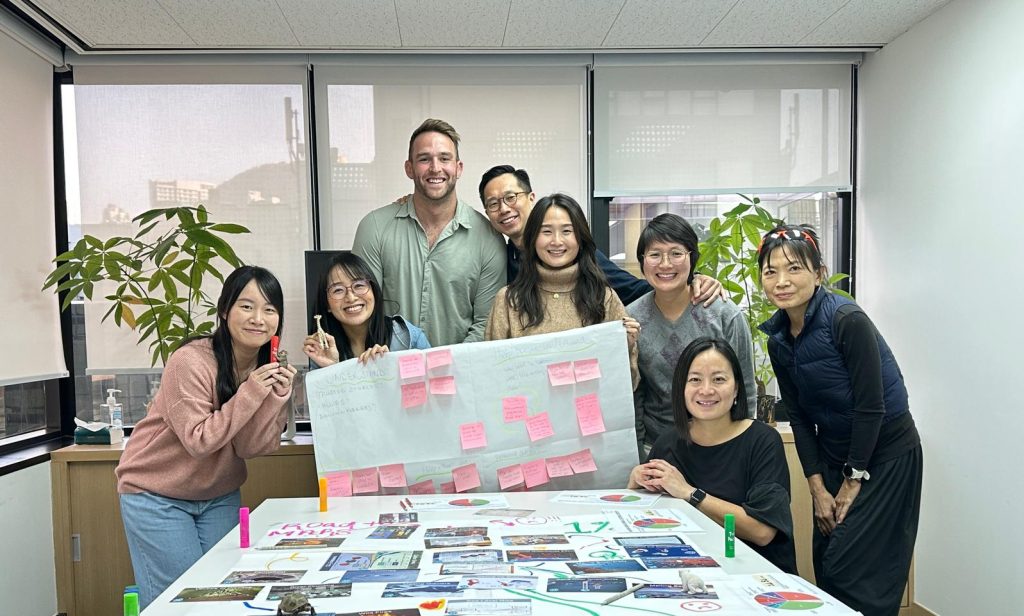 Leathwaite HK employees holding up work and smiling at camera