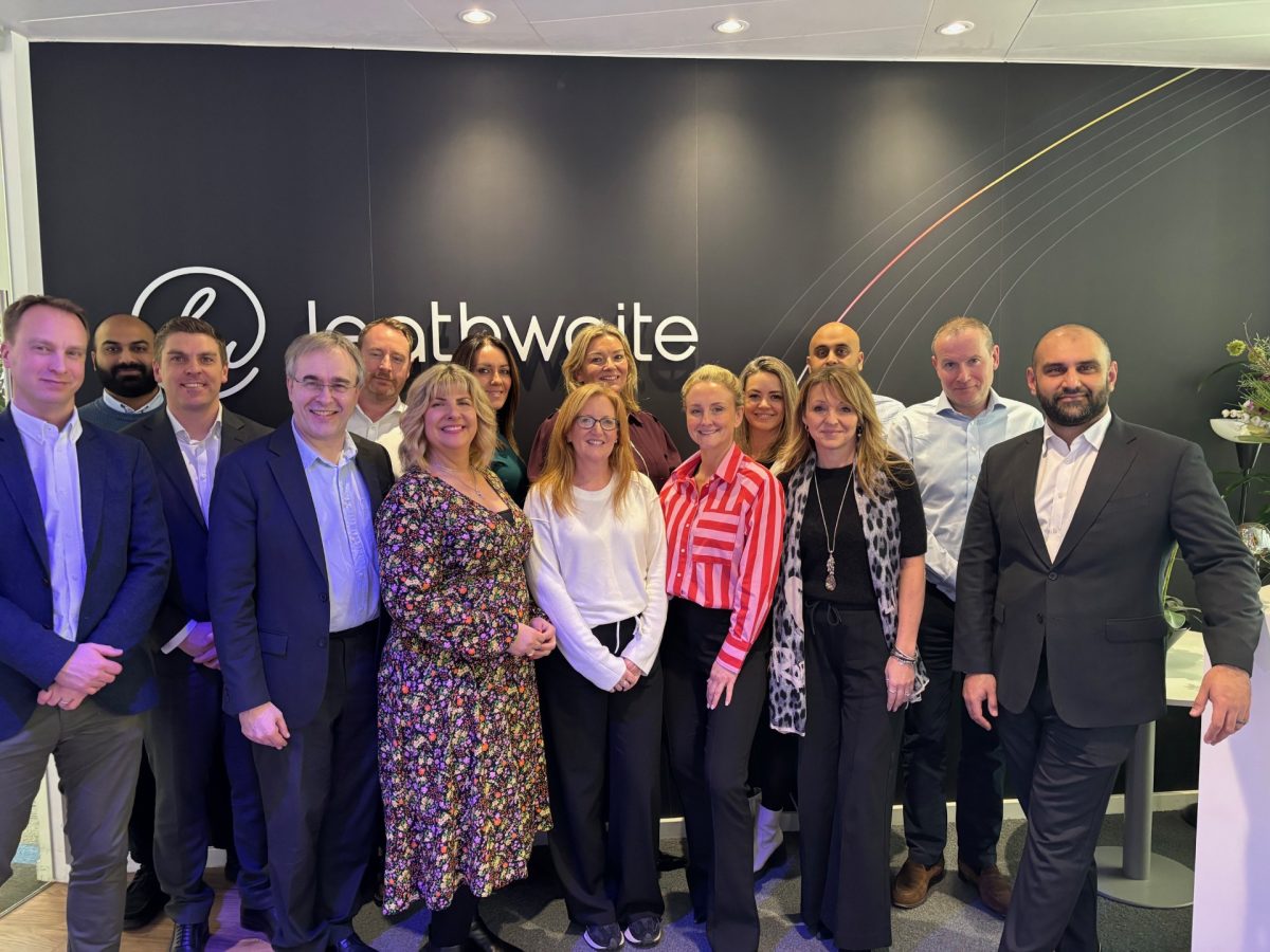 group of people standing in front of the Leathwaite logo