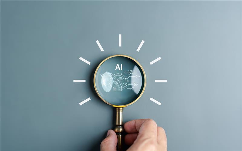 magnifying glass with AI in centre