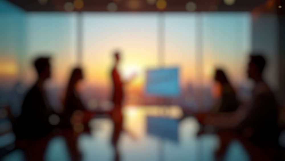 blurred image of boardroom meeting