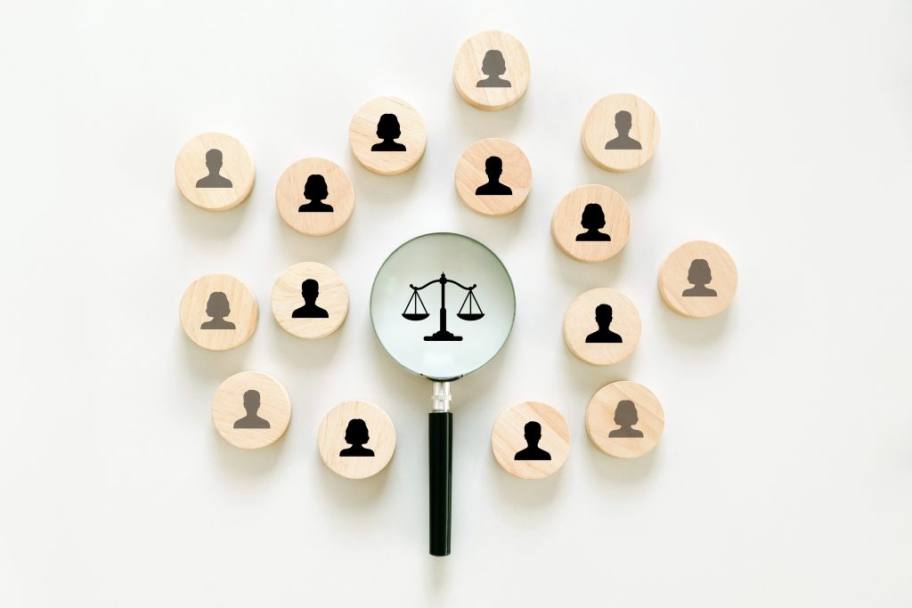 image of scales with icons of peoples heads around it