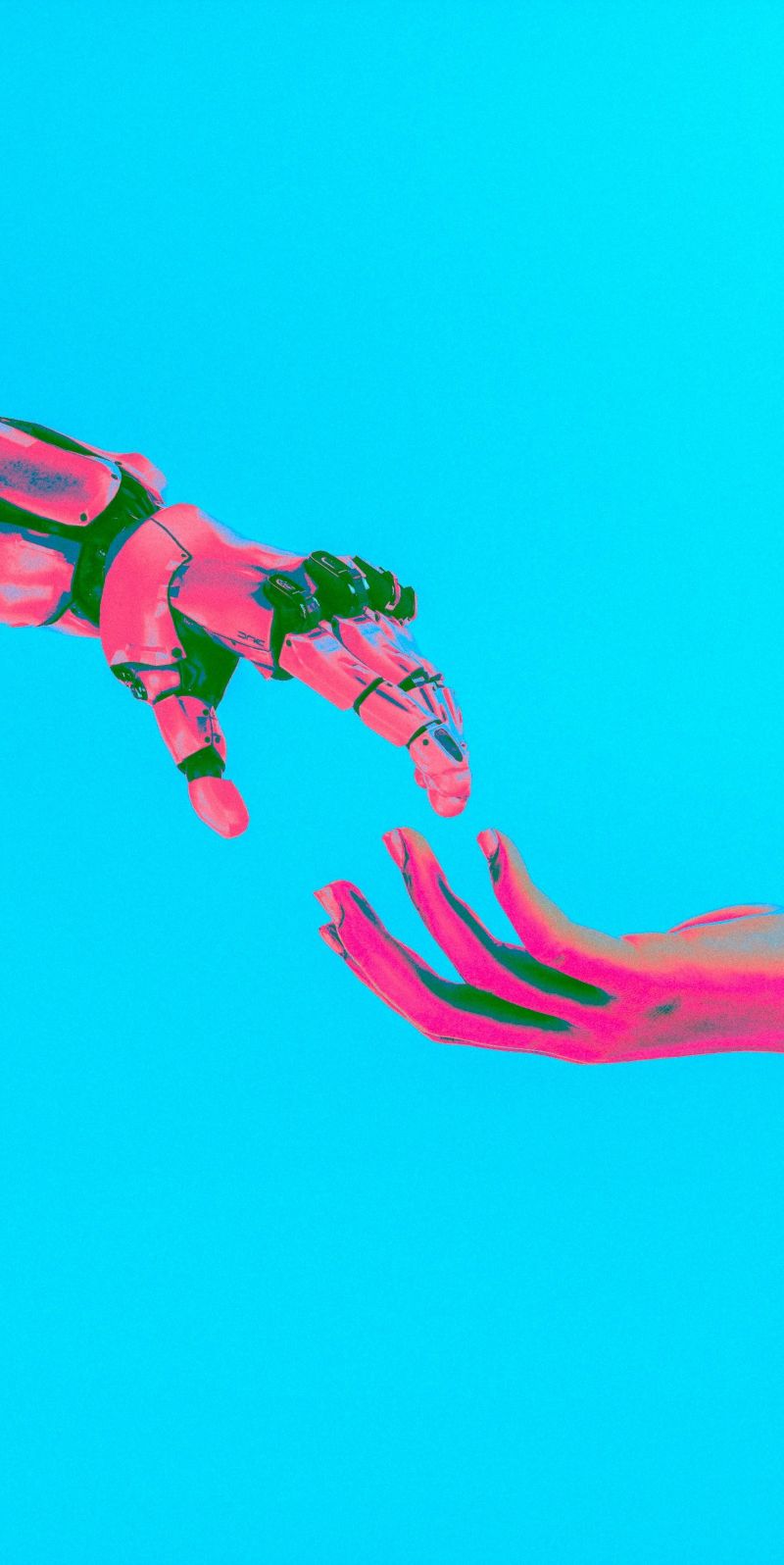 two hands, one robotic and one human