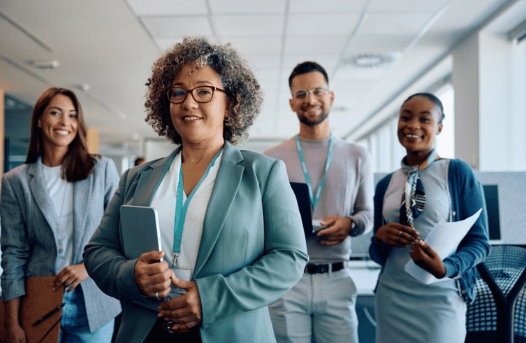 Business team members in an office, collaborating on interim leadership initiatives, showcasing diversity and professionalism.