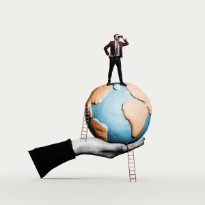Man on top of model of earth